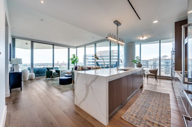 Kitchen featuring a sink, open floor plan, floor to ceiling windows, modern cabinets, and light wood finished floors | Image 5