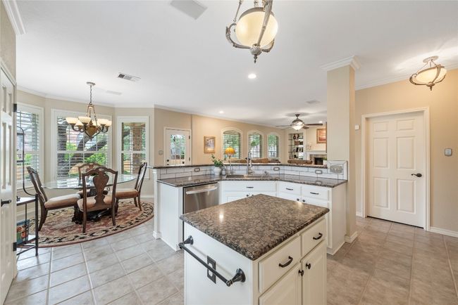 Bright and cheerful breakfast nook with bay windows, seamlessly connected to the kitchen and living room—ideal for casual meals. | Image 16