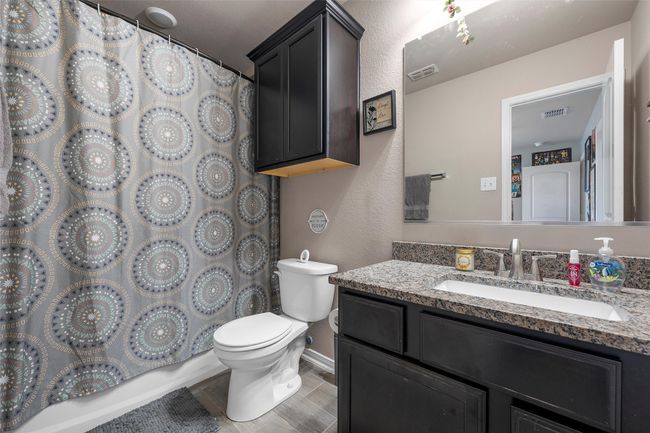 Bathroom featuring vanity and a shower with shower curtain | Image 26
