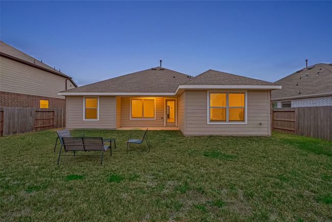 Step outside to enjoy the covered patio, perfect for outdoor relaxation, overlooking a sizable backyard with endless possibilities. | Image 38