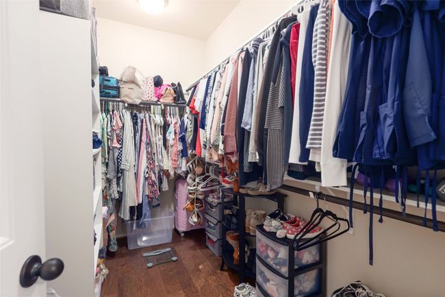 Walk in closet featuring wood finished floors | Image 18