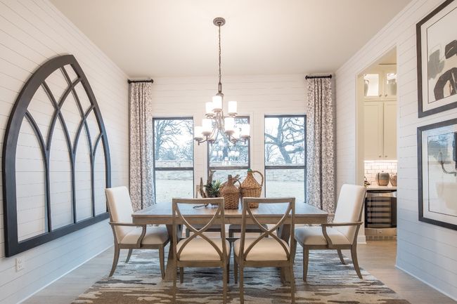 Dining area featuring wood finished floors, a chandelier, plenty of natural light, and wood walls | Image 10