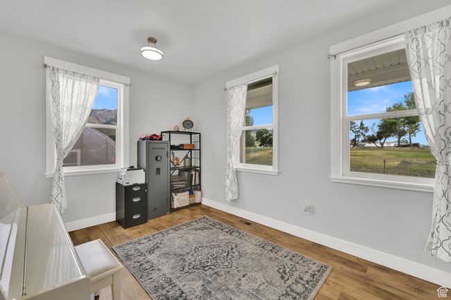 Home office with baseboards and wood finished floors | Image 7