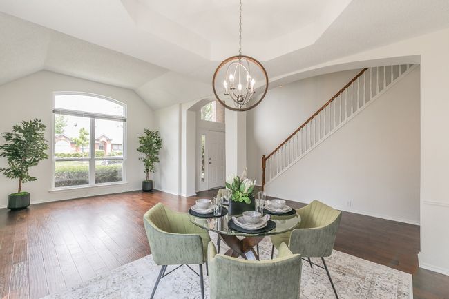 Dining area with stairway, hardwood / wood-style floors, baseboards, and a notable chandelier | Image 11
