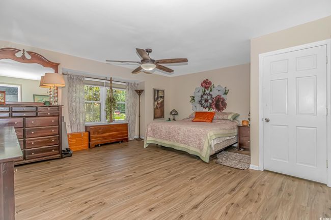 Bedroom featuring wood finished floors and a ceiling fan | Image 14
