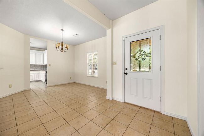 This is the front entry of the home that leads into the living room and formal dining area. | Image 7