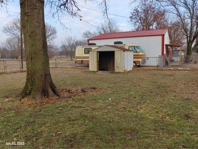 View of outbuilding with a lawn | Image 11