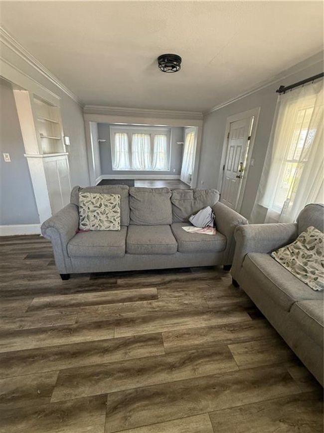 Living room with ornamental molding and dark wood-type flooring | Image 4