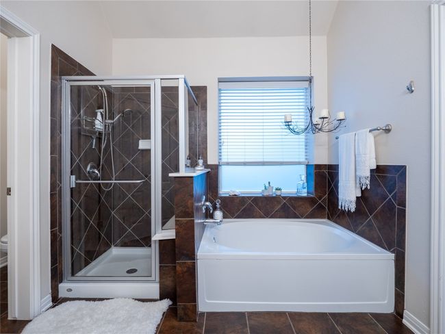 Primary bath has a separate shower with tile surround. | Image 16