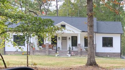 View of front facade featuring a front yard and a porch | Image 1