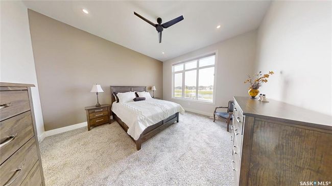 Bedroom featuring light carpet, lofted ceiling, a ceiling fan, and recessed lighting | Image 18