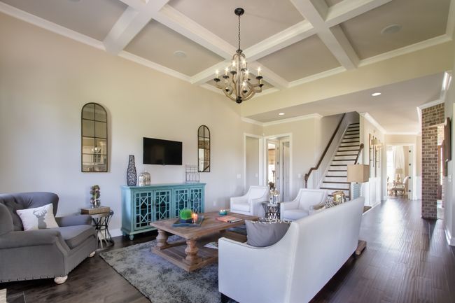 The spacious living room also features a coffered ceiling. | Image 16