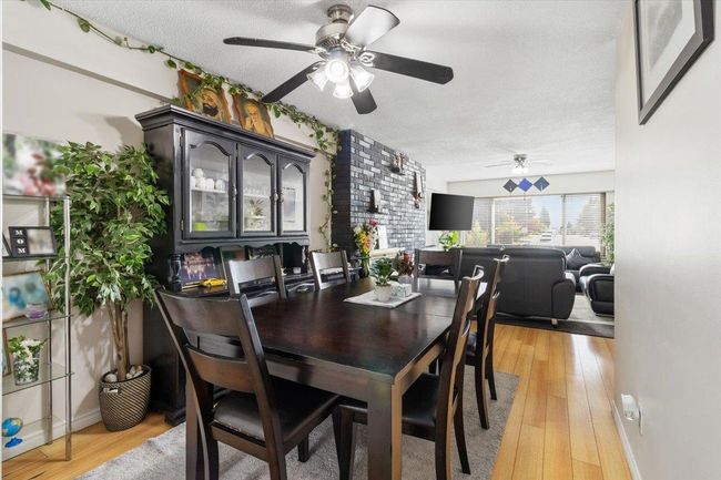 Dining room featuring a ceiling fan, light wood finished floors, and a textured ceiling | Image 10