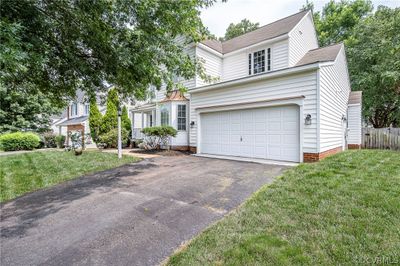 View of front facade with a garage and a front yard | Image 2