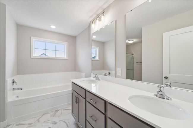 Owner's bath with dual vanity, shower, and soaking tub. This is not the actual home for sale, but photos of the same floorplan. Additional options may be shown. | Image 12