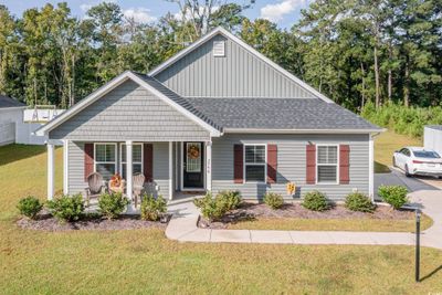 View of front of home with a front lawn and a porch | Image 1