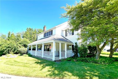 View of front facade with a front yard and covered porch | Image 2