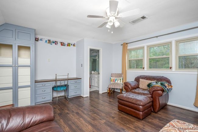 Level 3 bedroom or sitting area with built-in desk and storage | Image 56