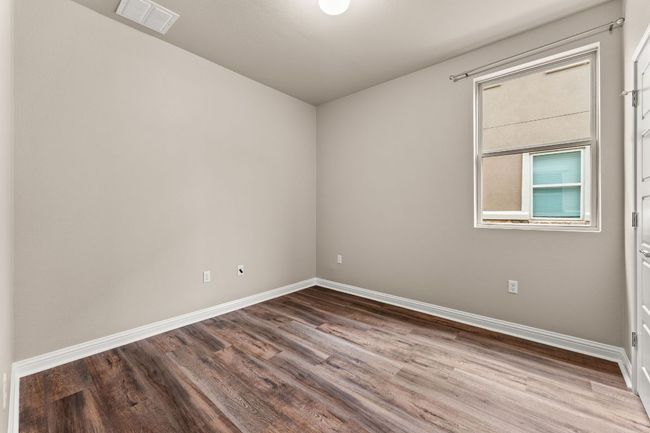 Empty room with wood finished floors and baseboards | Image 17