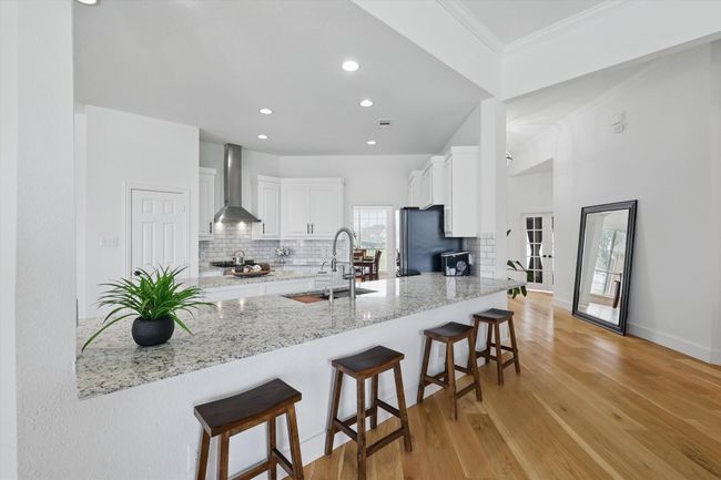 Granite countertops, stainless steel appliances and elegant recessed lighting. | Image 13
