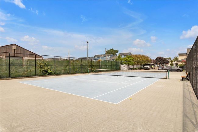 View of tennis court with fence and community basketball court | Image 25