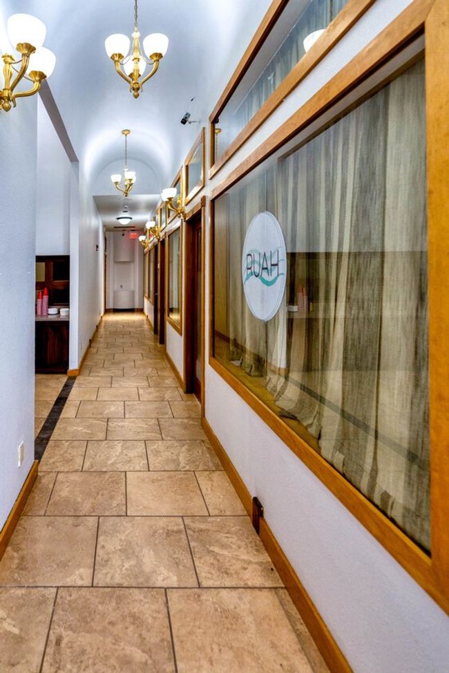 Hall with a chandelier and stone tile flooring | Image 4