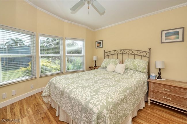 Bedroom featuring ceiling fan, hardwood / wood-style floors, and ornamental molding | Image 17