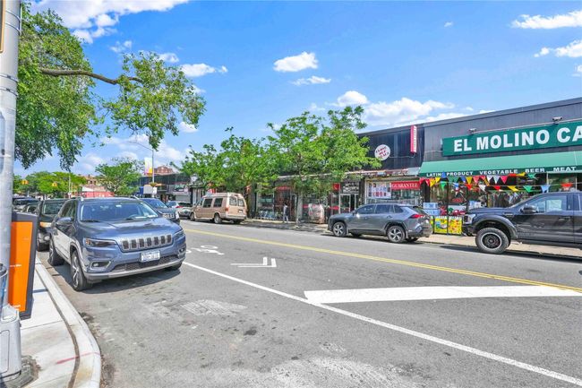 View of asphalt road featuring curbs, street lighting, and sidewalks | Image 31