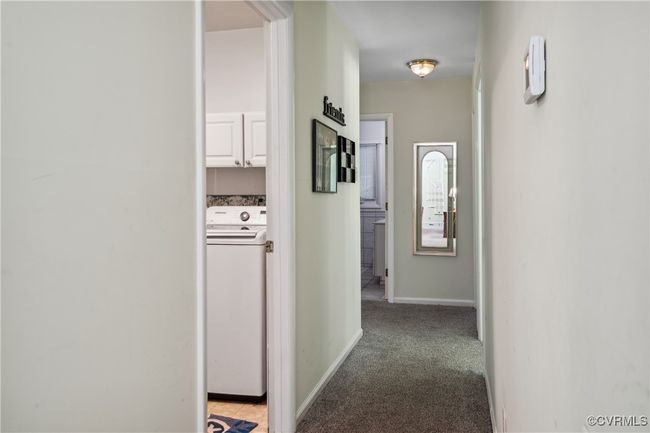 Hall featuring washer / clothes dryer and light carpet | Image 12