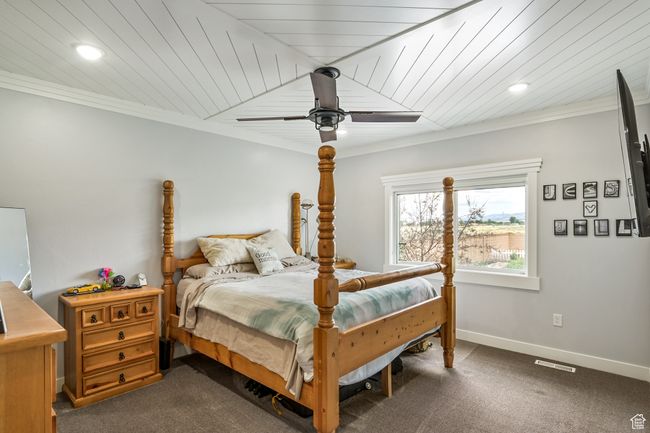 Bedroom with dark carpet, ornamental molding, recessed lighting, and ceiling fan | Image 38