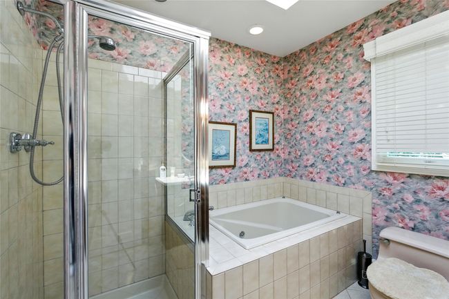 Bathroom with wallpapered walls, a jetted tub, a shower stall, and recessed lighting | Image 34