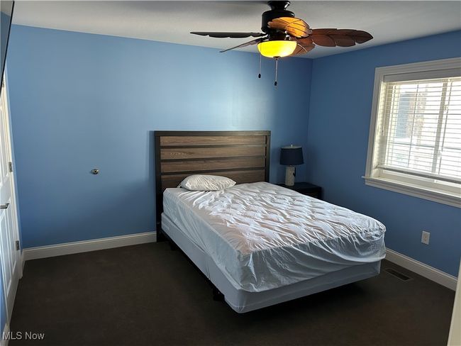 Bedroom featuring visible vents, baseboards, and ceiling fan | Image 4