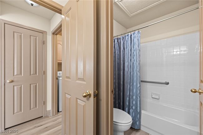 Full bathroom with wood finished floors and shower / bathtub combination with curtain | Image 25