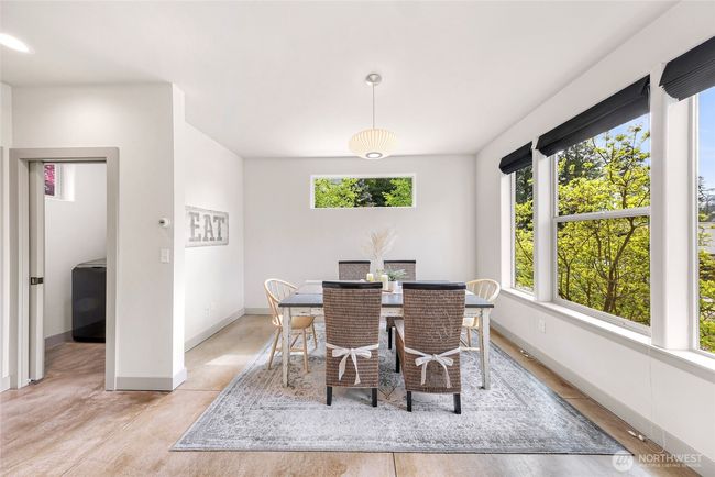 Back on the main level is an official dining room or can be used as a family room. Off to the left is the laundry room, and a half bathroom. | Image 17