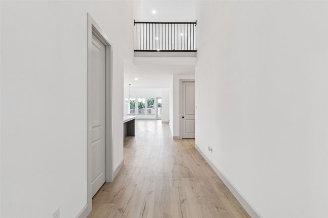 Open the door, step inside and experience high ceilings, open railing and site lines through to the rear of this dream home! | Image 4
