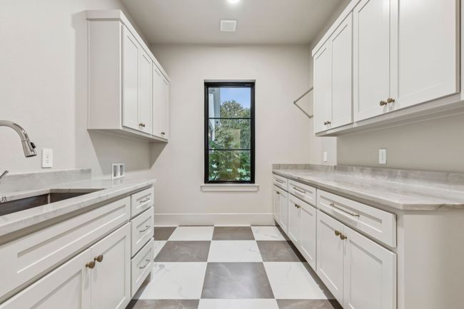 Washroom with hookup for a washing machine and cabinet space | Image 21