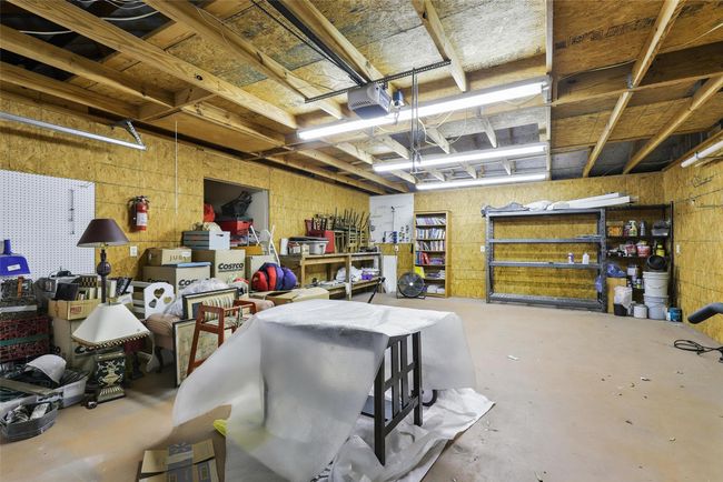featuring a workshop area and a garage | Image 34