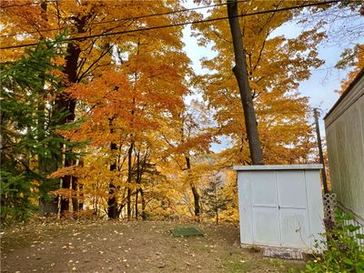 Large side yard with view of the park and creek below. Shed | Image 3