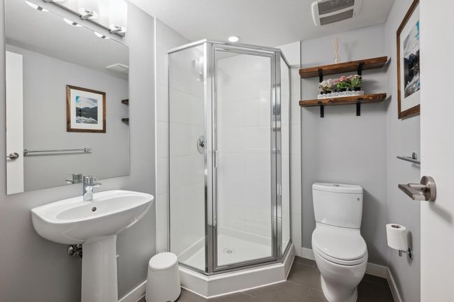 Full bath featuring toilet, a shower stall, tile patterned flooring, and baseboards | Image 35