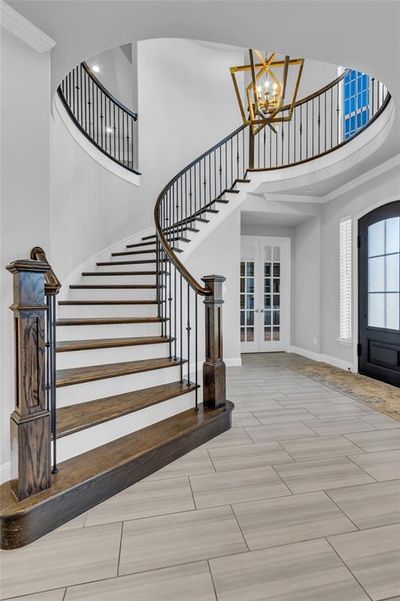 Stunning entry with circular staircase featuring wood stairs | Image 3