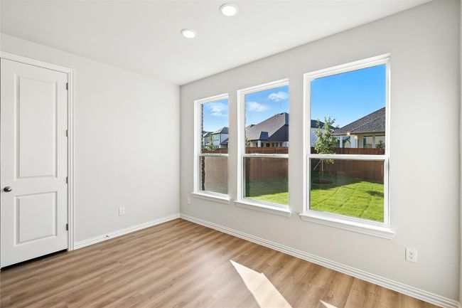 Spare room featuring healthy amount of natural light, light wood-style floors, and recessed lighting | Image 7