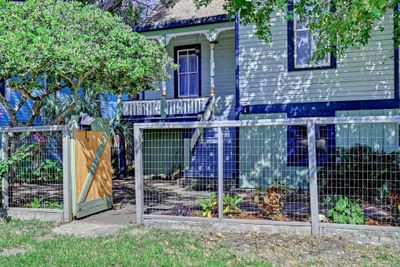 High fence encloses the front yard of this unusually large lot. | Image 3