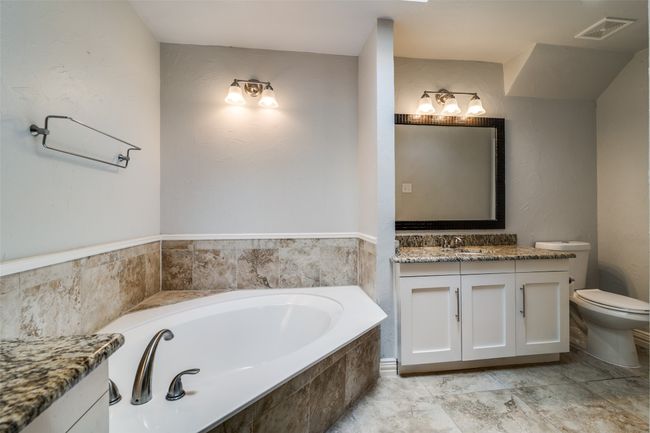Primary bath second vanity and garden tub. The second walk in closet is located at the far right. | Image 19