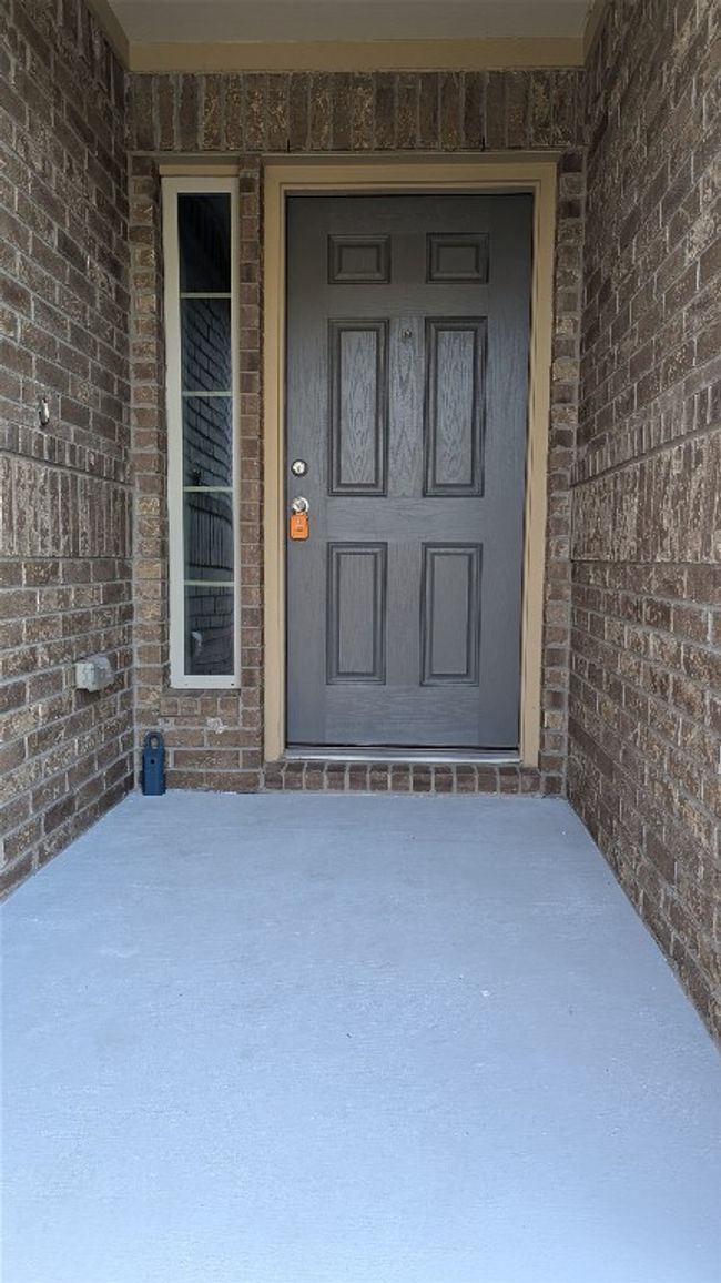 View of exterior entry with brick siding | Image 10
