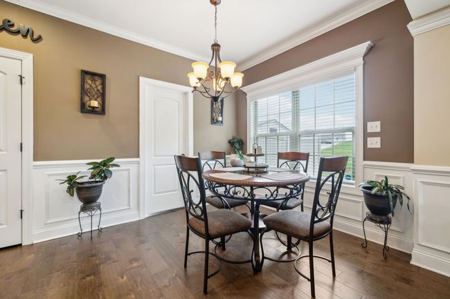 Just off the kitchen, the eat-in area features a large window and charming wainscoting, creating an inviting space for meals.1107 Sycamore Leaf Way Murfreesboro, TN 37129 | Image 12