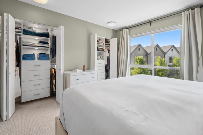 Bedroom featuring light carpet and a walk in closet | Image 24