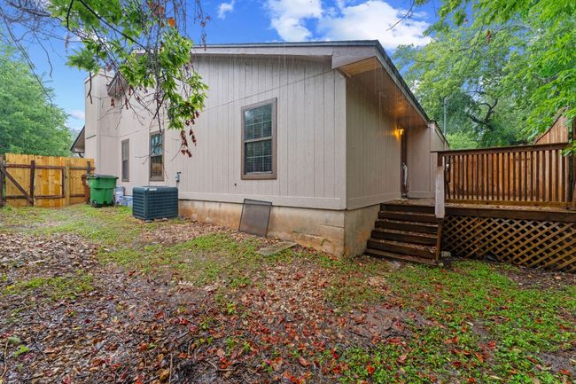 View of side of property featuring a deck and a central AC unit | Image 29