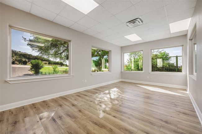Spare room with a paneled ceiling, visible vents, baseboards, and light wood-type flooring | Image 23