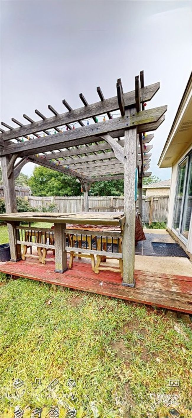 Wooden deck featuring a pergola and a fenced backyard | Image 10