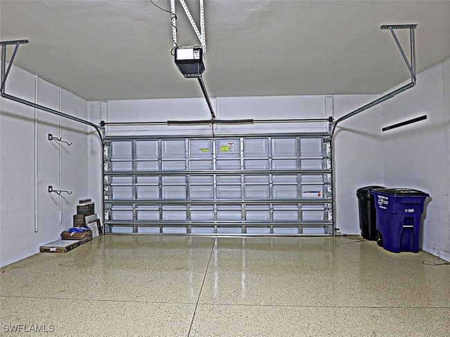 Garage with a garage door opener and concrete block wall | Image 28